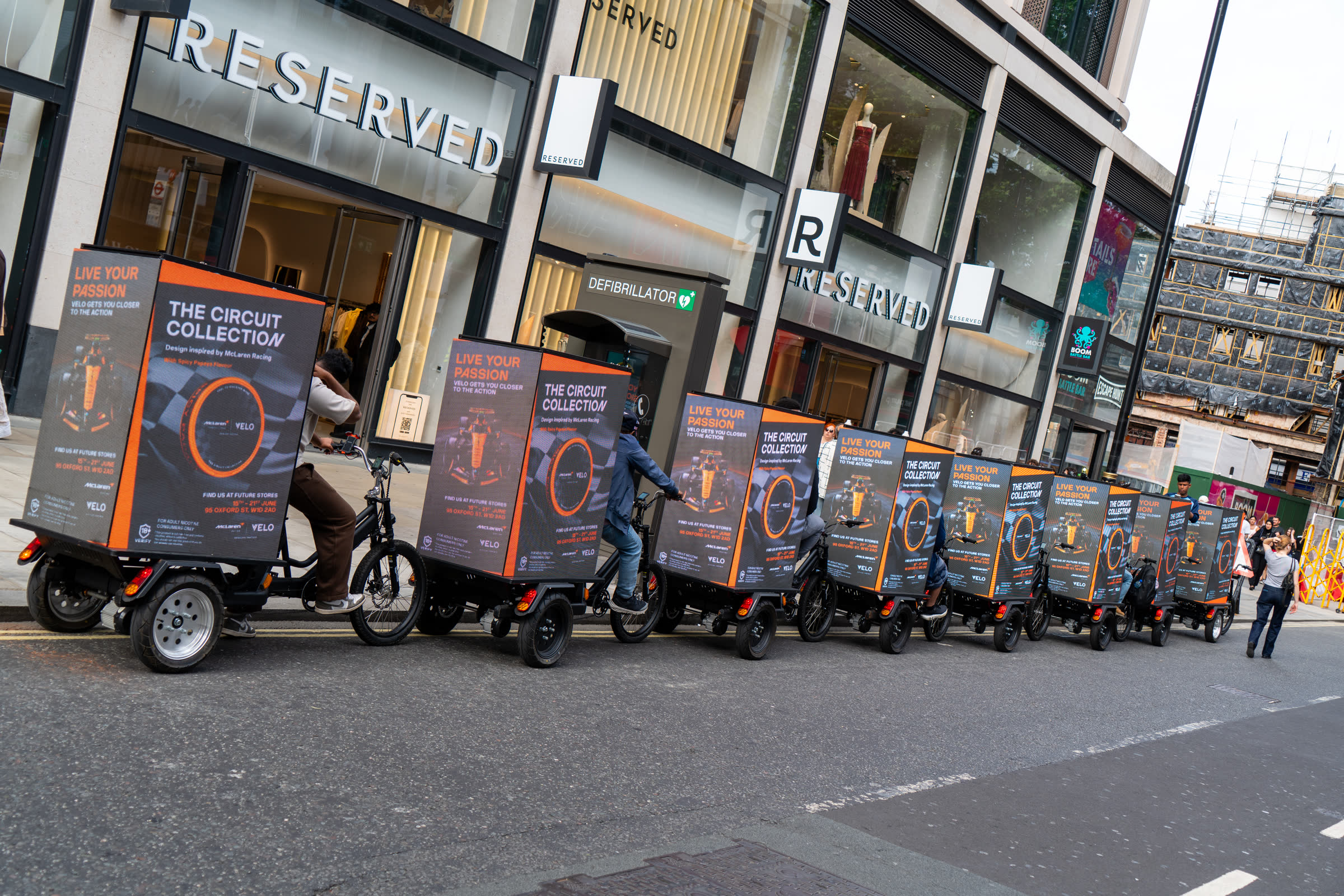 The Monster AdBike convoy lined up on Oxford Street for the Velo x McLaren campaign