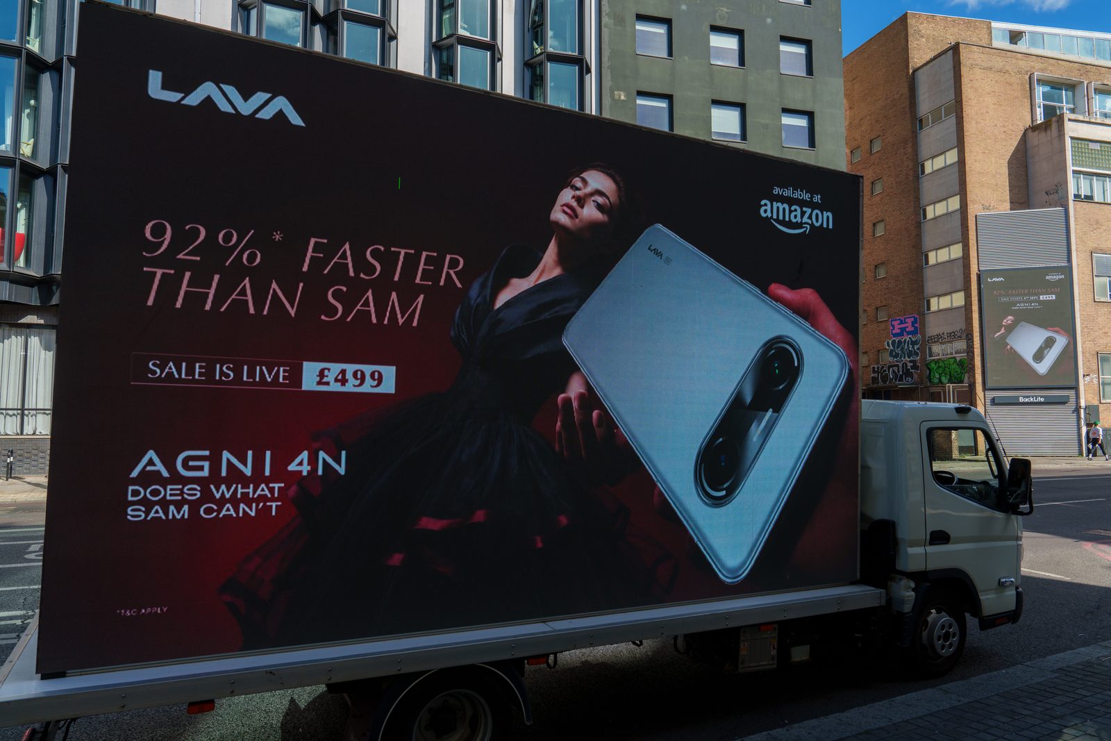 The digital AdVan carrying the LAVA AGNI 4N sale is live artwork on Shoreditch High Street, with a roadside screen showing the same campaign behind it