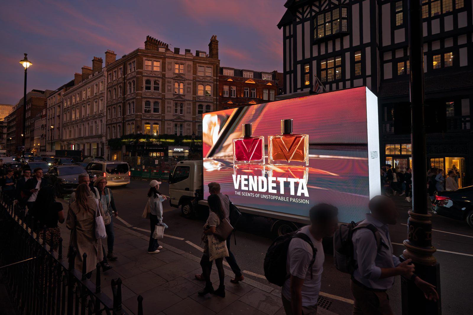 A Monster AdVan showing the two Vendetta bottles on Great Marlborough Street at the corner of Carnaby Street at dusk