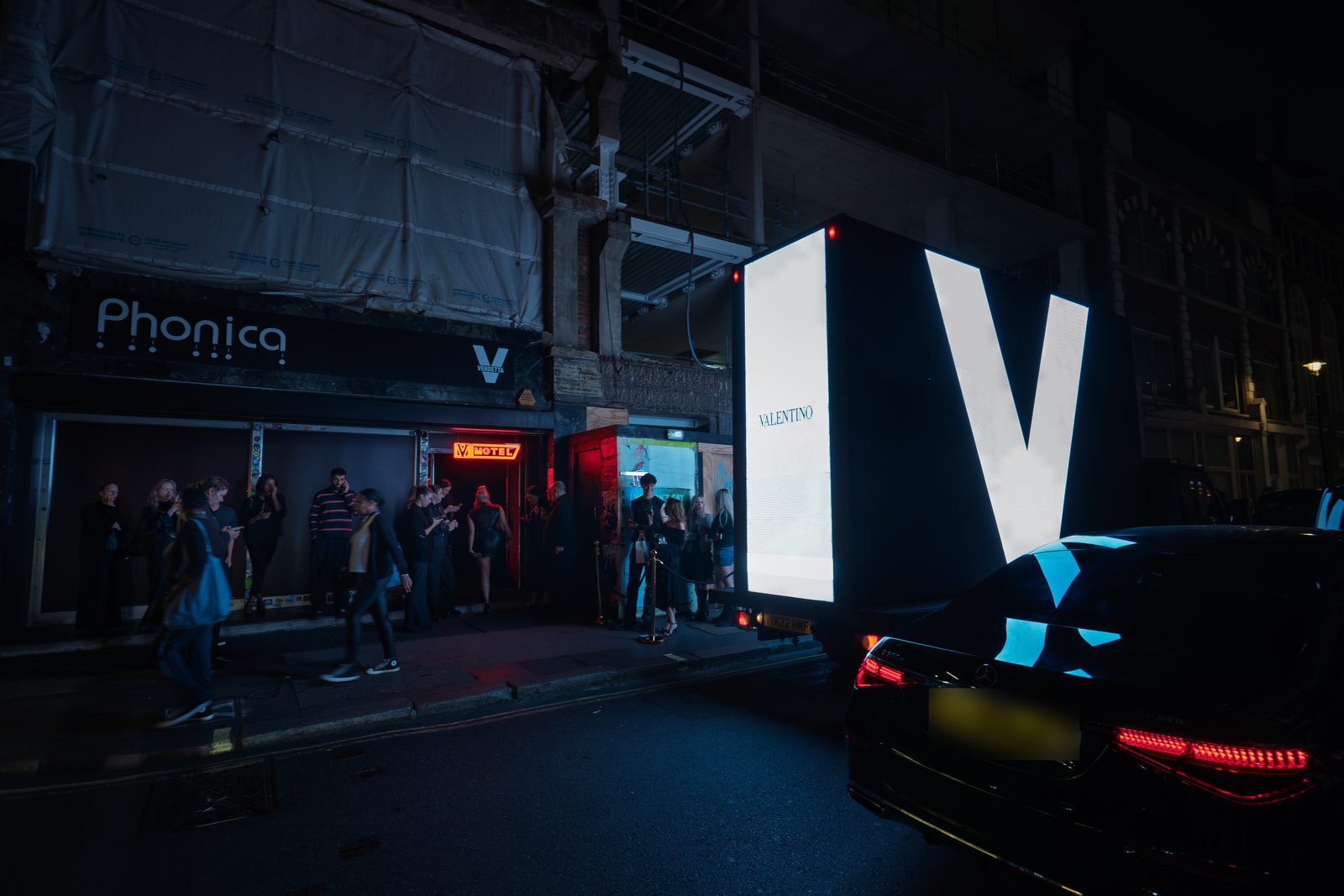 The giant white V on the back of a Monster AdVan passing the Valentino Vendetta launch party at Phonica on Poland Street, Soho