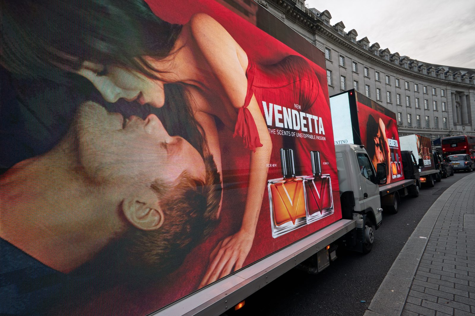 The Valentino Vendetta artwork filling the side of a Monster AdVan on Regent Street in daylight, with two more vans in convoy behind